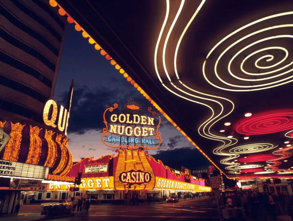 A street with neon signs.