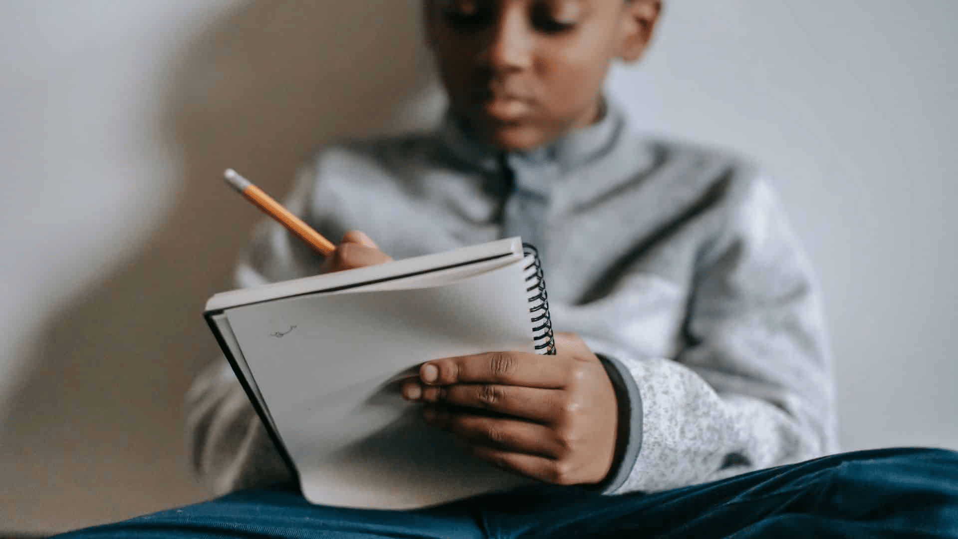 A kid writing on a paper