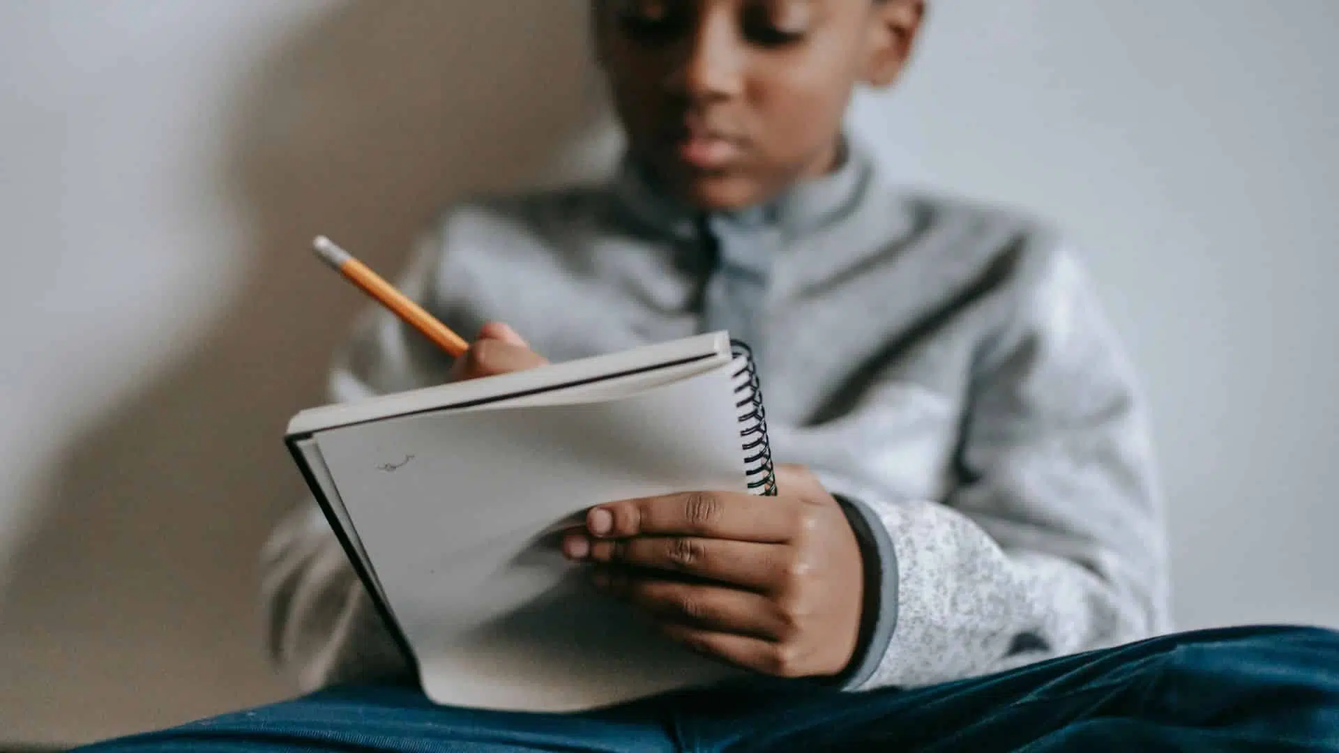 A kid writing on a paper