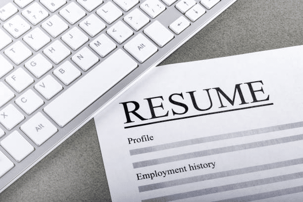 resumes-on-laptop-with-glasses-resume-review-job-interview