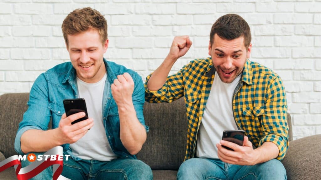 Two men excited while watching their phone