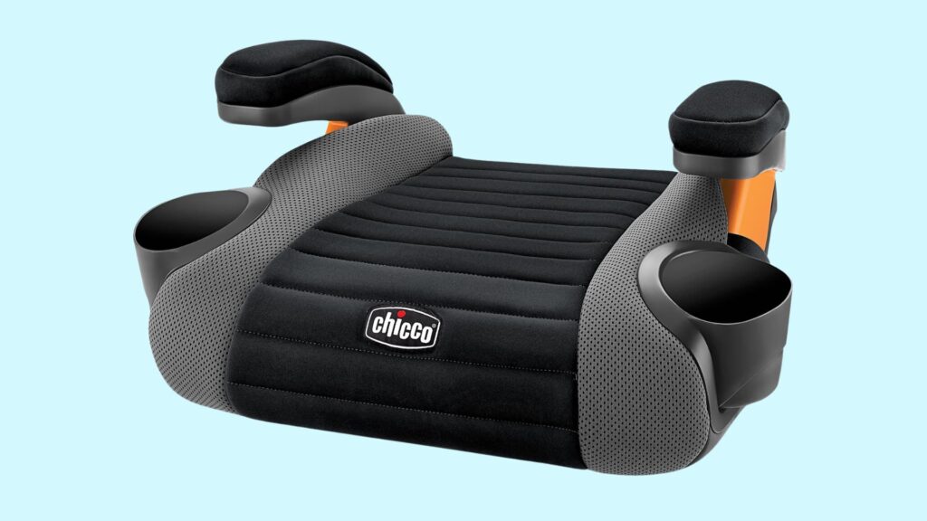 Backless booster car seat in black and gray with armrests and dual cup holders, shown on a light blue background